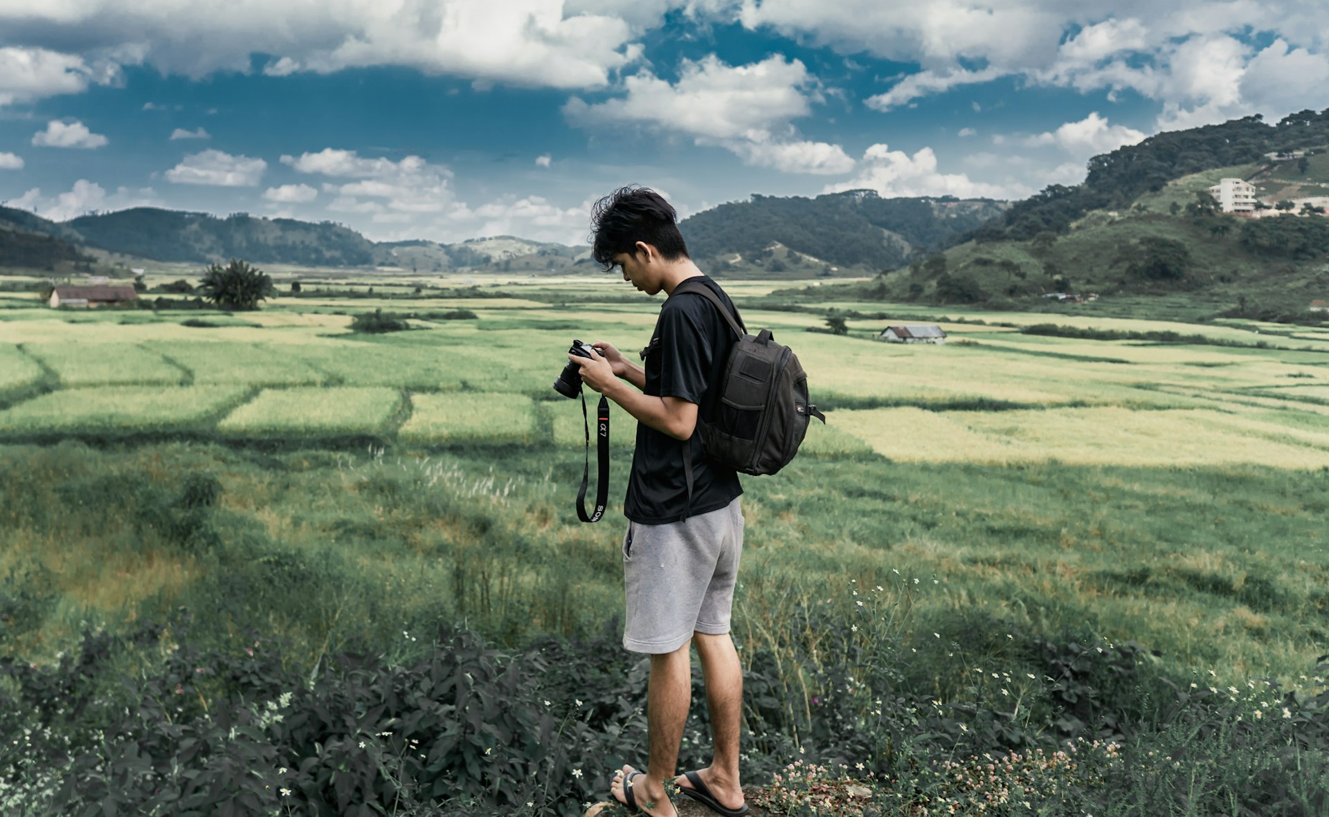 man in black jacket and white shorts standing on green grass field during daytime